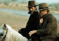 Scena del film "Gli spietati". Morgan Freeman e Clint Eatswood a cavallo.